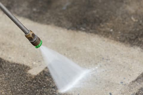 Pressure washing a concrete driveway